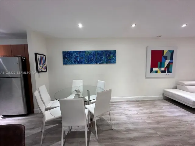 a view of a dining room with furniture wooden floor and a rug