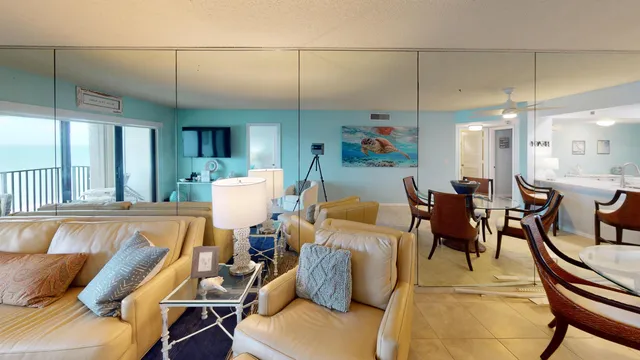 a living room with furniture a dining table and chairs with kitchen view