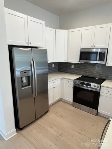 a kitchen with a sink a window and cabinets