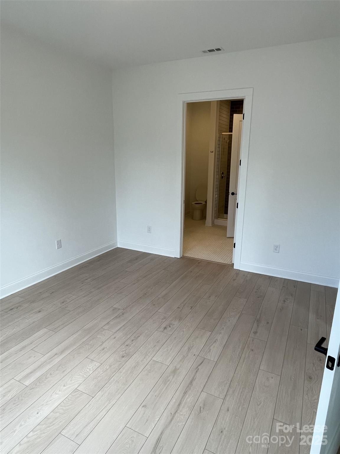 19546 Greentree Way, Unit 203 Cornelius, NC 28031 - Photo 22 of 32 an empty room with wooden floor and closet