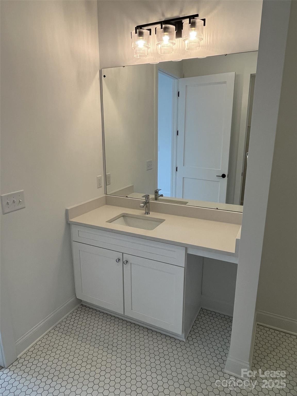 19546 Greentree Way, Unit 203 Cornelius, NC 28031 - Photo 23 of 32 a bathroom with a sink and a mirror