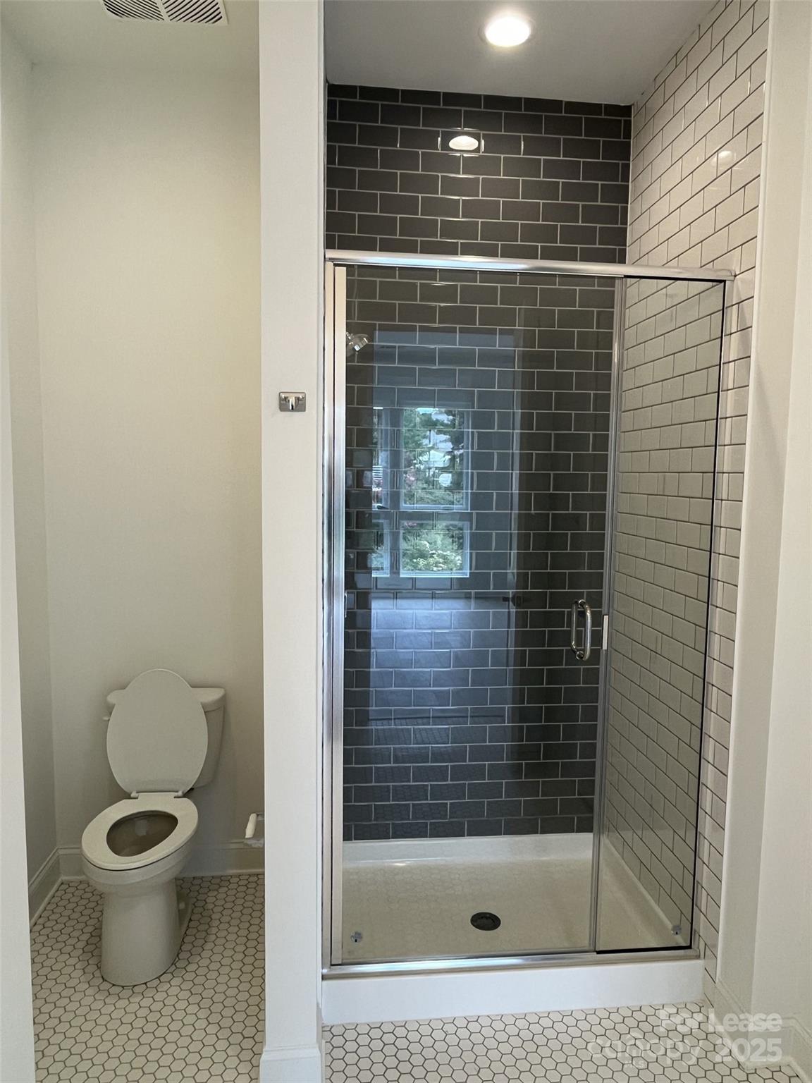 19546 Greentree Way, Unit 203 Cornelius, NC 28031 - Photo 24 of 32 a bathroom with a toilet and a shower