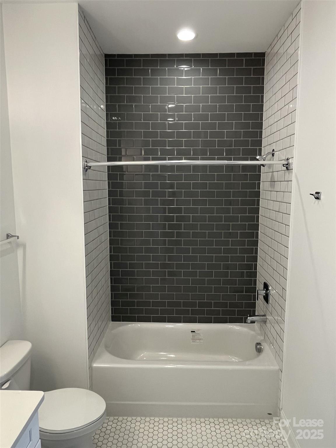 19546 Greentree Way, Unit 203 Cornelius, NC 28031 - Photo 30 of 32 a bathroom with a bathtub and a toilet