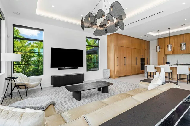 a kitchen with stainless steel appliances kitchen island granite countertop a table chairs and a refrigerator