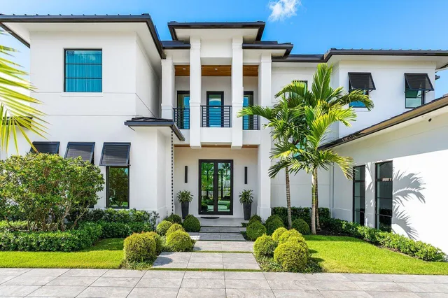a view of a house with a yard and garage