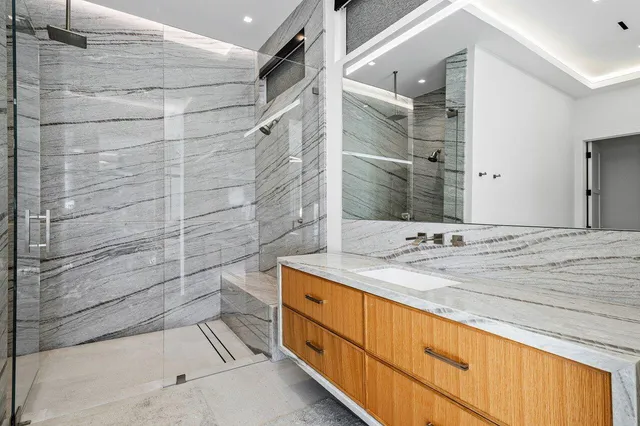 a view of a patio with a table chairs and a floor to ceiling window