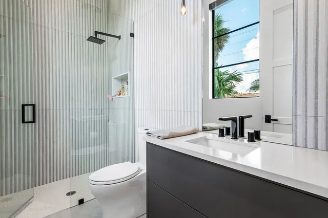 a view of a lake with lawn chairs under an umbrella