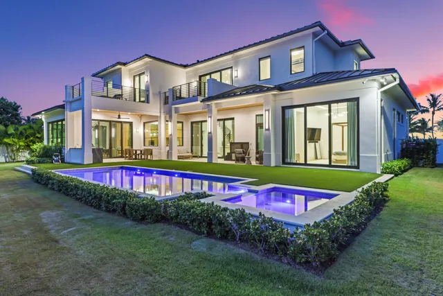 a front view of a house with a garden and yard