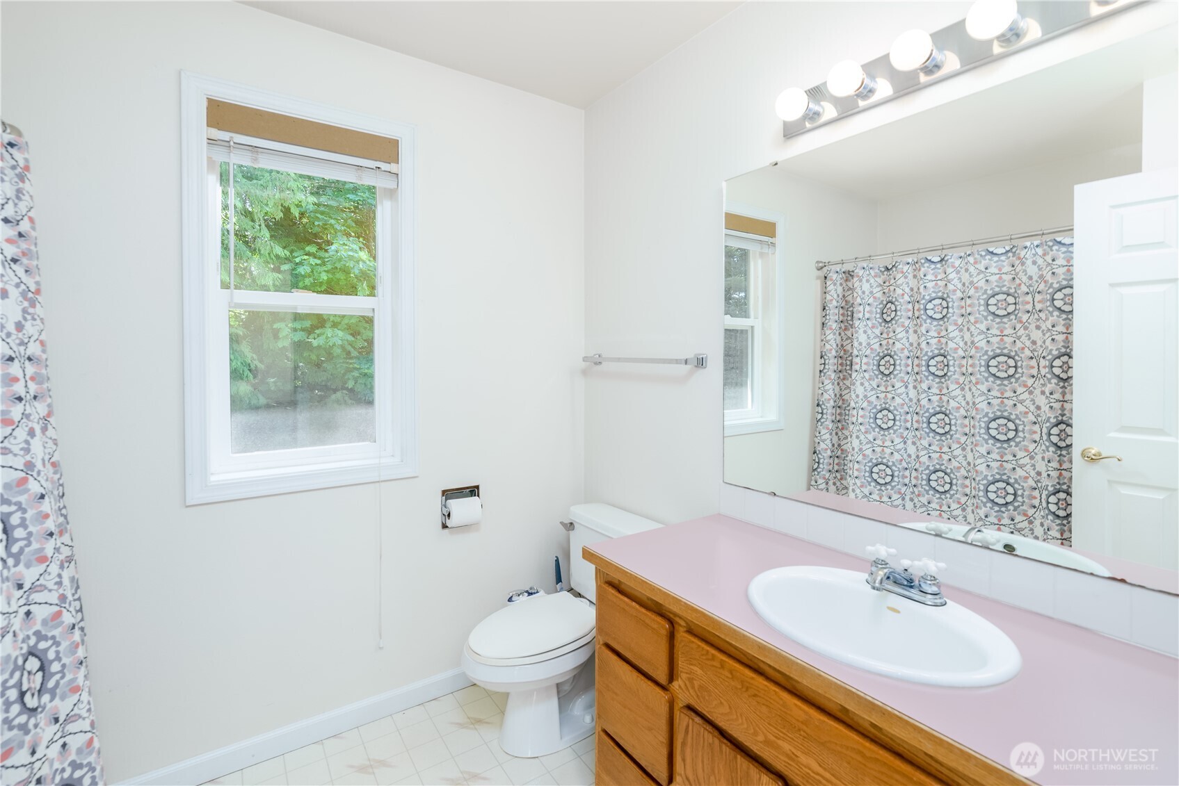 301 Mt Pleasant Estates Road Port Angeles, WA 98362 - Photo 21 of 40 a bathroom with a sink vanity granite toilet and a mirror