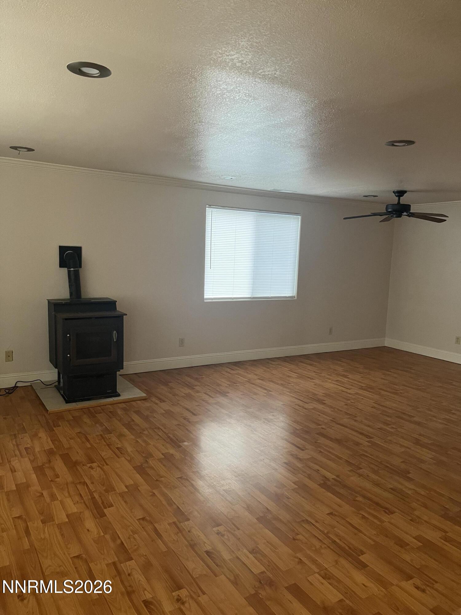 3300 White Lake Parkway Reno, NV 89508 - Photo 2 of 17 a view of an empty room with wooden floor and a window