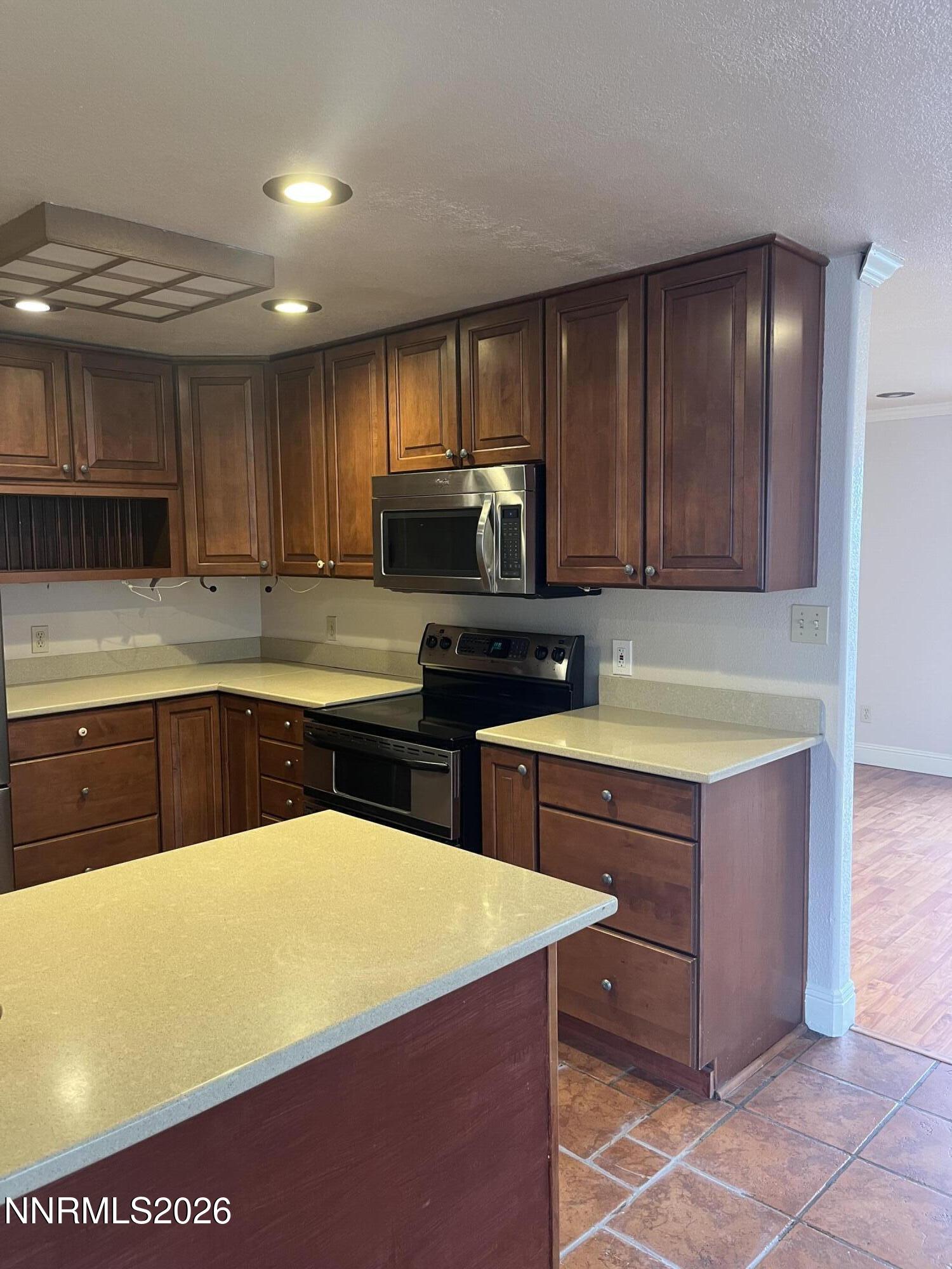 3300 White Lake Parkway Reno, NV 89508 - Photo 9 of 17 a kitchen with wooden cabinets a sink and a stove