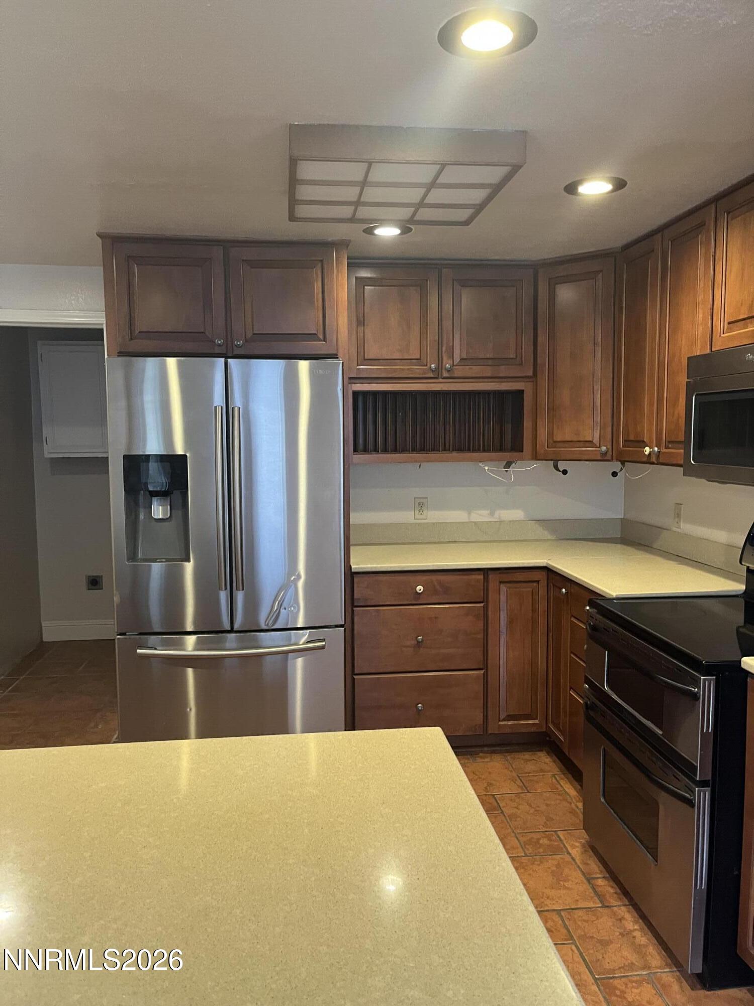 3300 White Lake Parkway Reno, NV 89508 - Photo 10 of 17 a kitchen with kitchen island granite countertop a refrigerator and cabinets