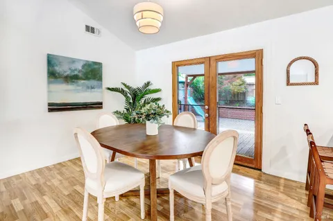 a view of a dining room with furniture window and wooden floor