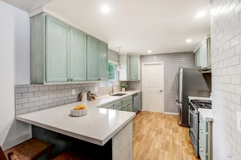 a kitchen with a sink a stove and a refrigerator