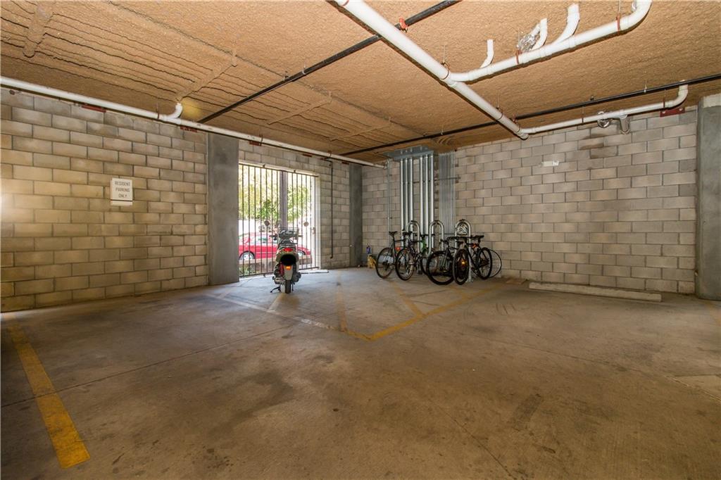 1401 East 4th Street, Unit 312 Austin, TX 78702 - Photo 16 of 16 a view of a patio with table and chairs and a barbeque