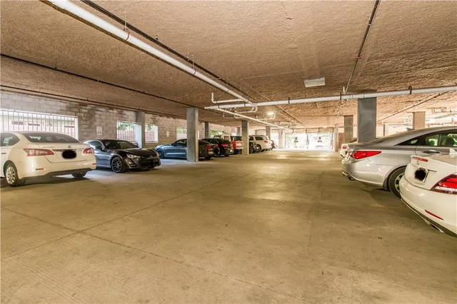 a view of parking garage with cars