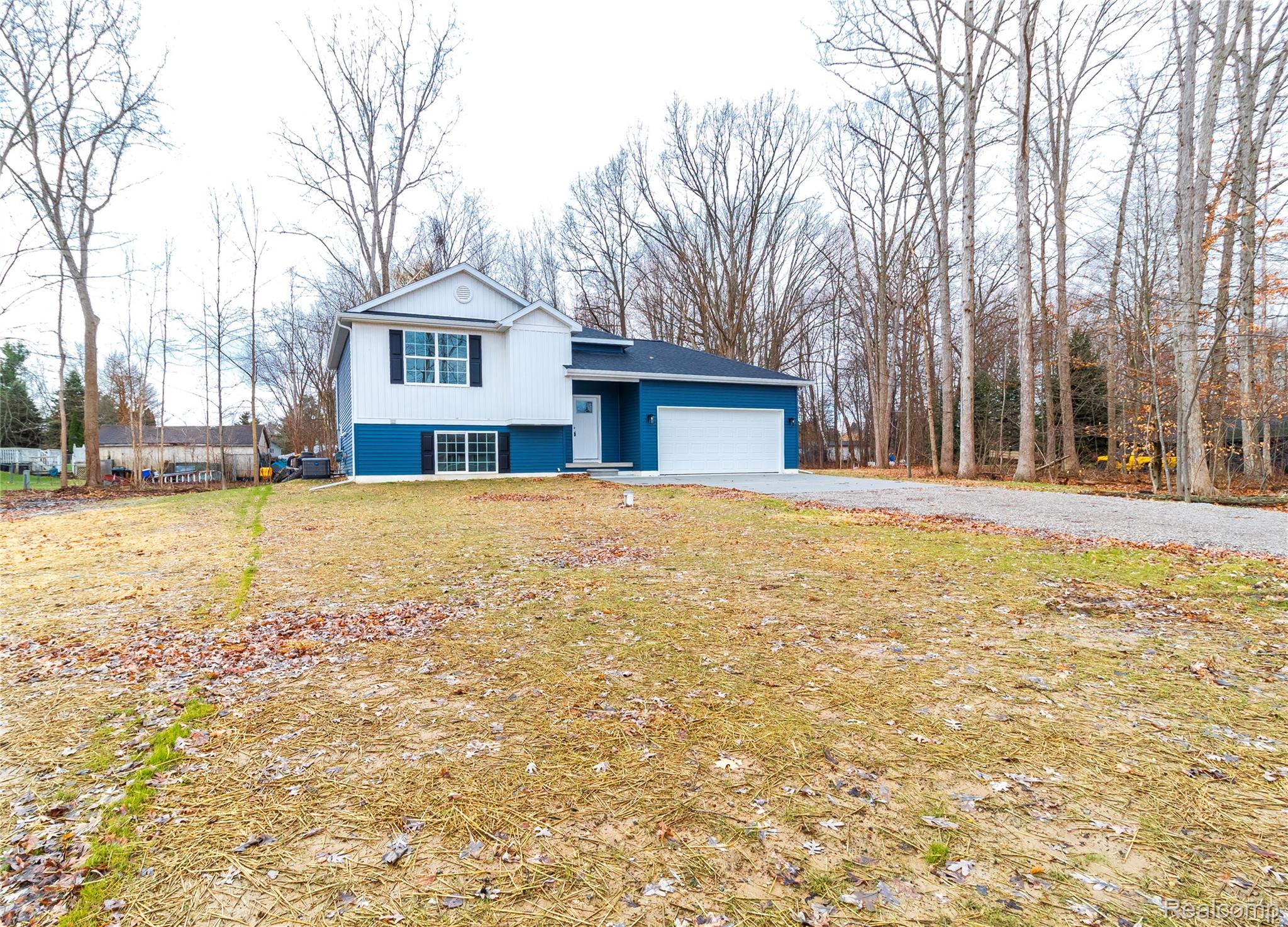 5155 Coldwater Road Lapeer, MI 48446 - Photo 24 of 24 Split level home with a garage, driveway, and a front yard