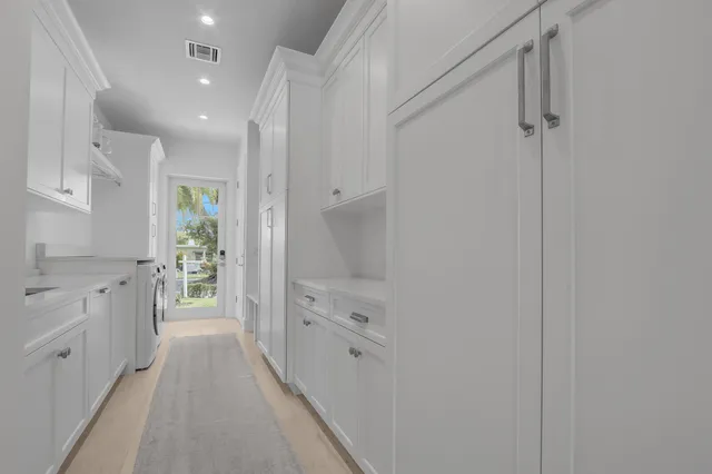 a view of a hallway with washer and dryer