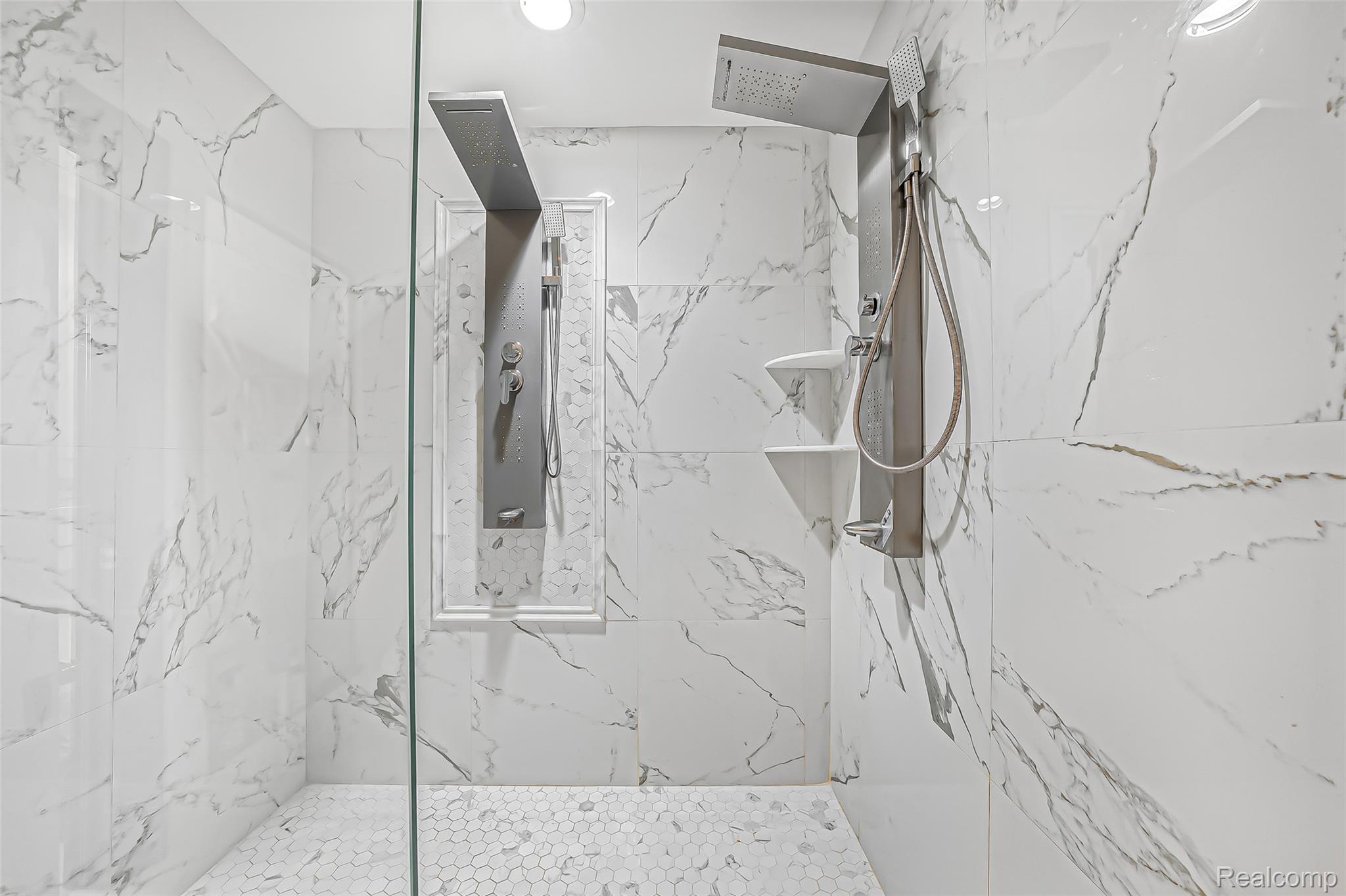 2785 Cranbrook Ridge Court Rochester, MI 48306 - Photo 41 of 99 Walk-in shower with full height white marble-look tiling, dual shower systems, and mosaic tile flooring