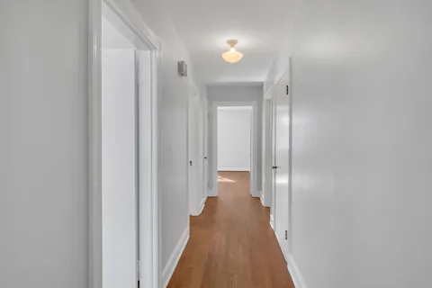 a view of a hallway with a wooden floor