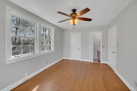 a view of a big room with wooden floor and windows in a room