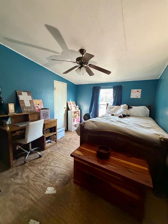 721 Richardson Road Stonewall, LA 71078 - Photo 7 of 11 a bedroom with a bed and a chandelier