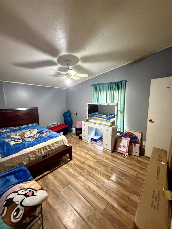 721 Richardson Road Stonewall, LA 71078 - Photo 9 of 11 a bedroom with furniture and a flat screen tv