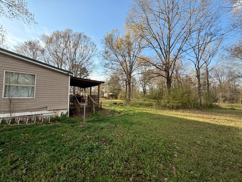 721 Richardson Road Stonewall, LA 71078 - Photo 10 of 11 a backyard of a house with table and chairs