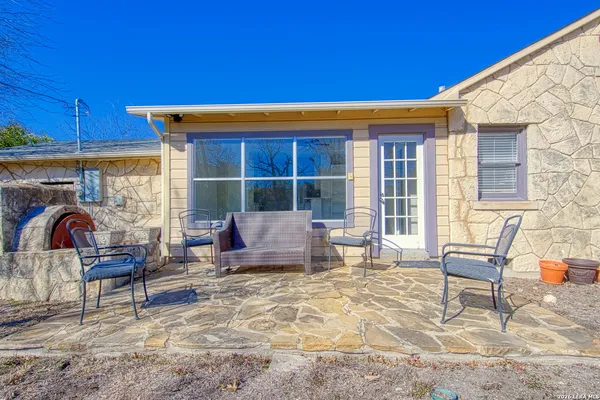 a view of a backyard with furniture and a fire pit