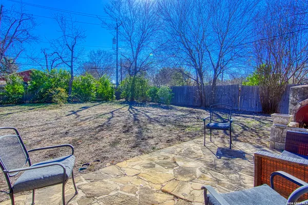 a view of house with backyard and trees