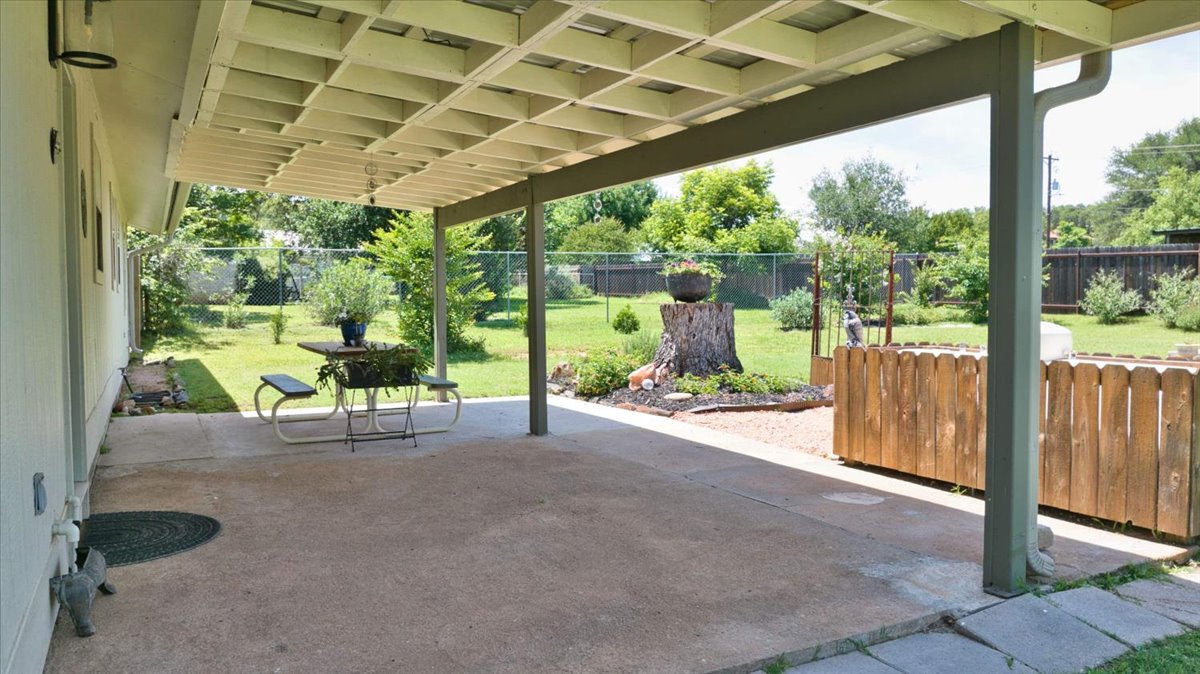 1236 Martin Street Mason, TX 76856 - Photo 30 of 40 An inviting covered patio opens to a verdant yard, offering a tranquil outdoor retreat.