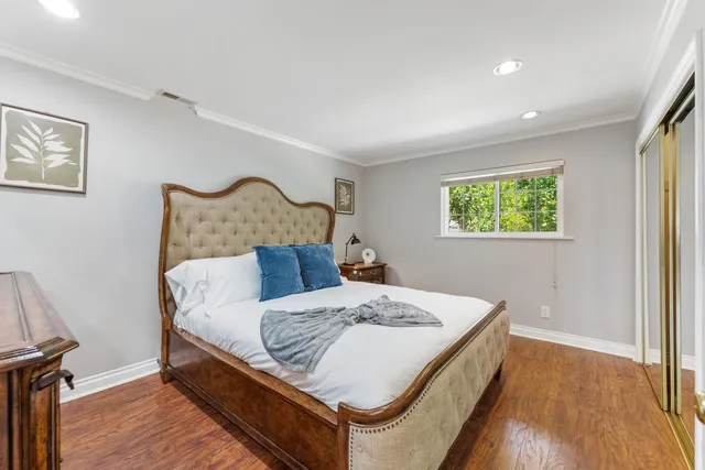a bed sitting in a bedroom next to a window