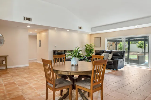 a view of a dining room with furniture and a potted plant