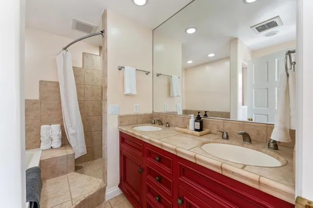 a bathroom with a sink double vanity and a mirror