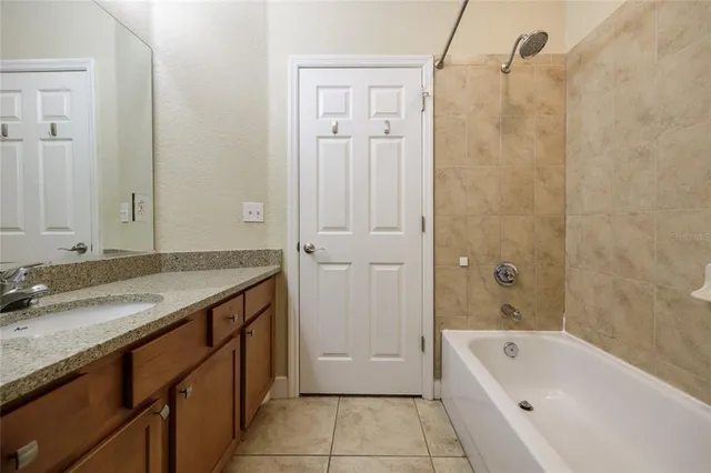 a bathroom with a granite countertop sink a toilet and shower