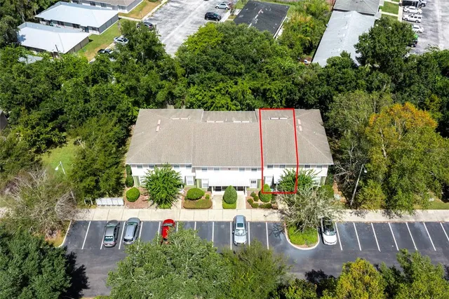 an aerial view of a house with swimming pool and outdoor seating