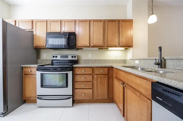 a kitchen with stainless steel appliances granite countertop a sink and a stove