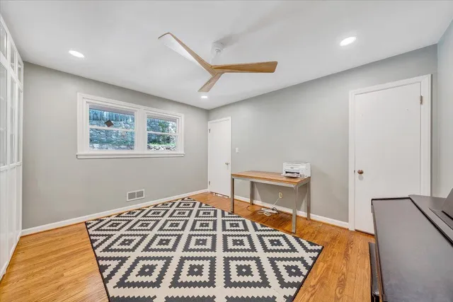a view of a patio with table and chairs with wooden floor and fence