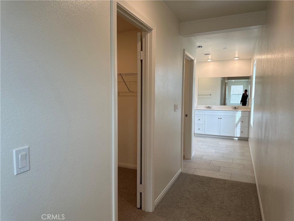 7560 Citrusmoon Court Riverside, CA 92507 - Photo 17 of 18 a view of a hallway with bathroom and a bathroom