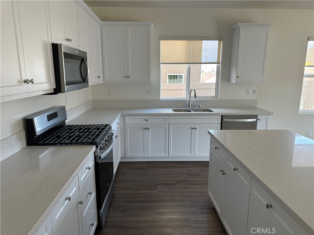 7560 Citrusmoon Court Riverside, CA 92507 - Photo 6 of 18 a kitchen with cabinets appliances a sink and a window