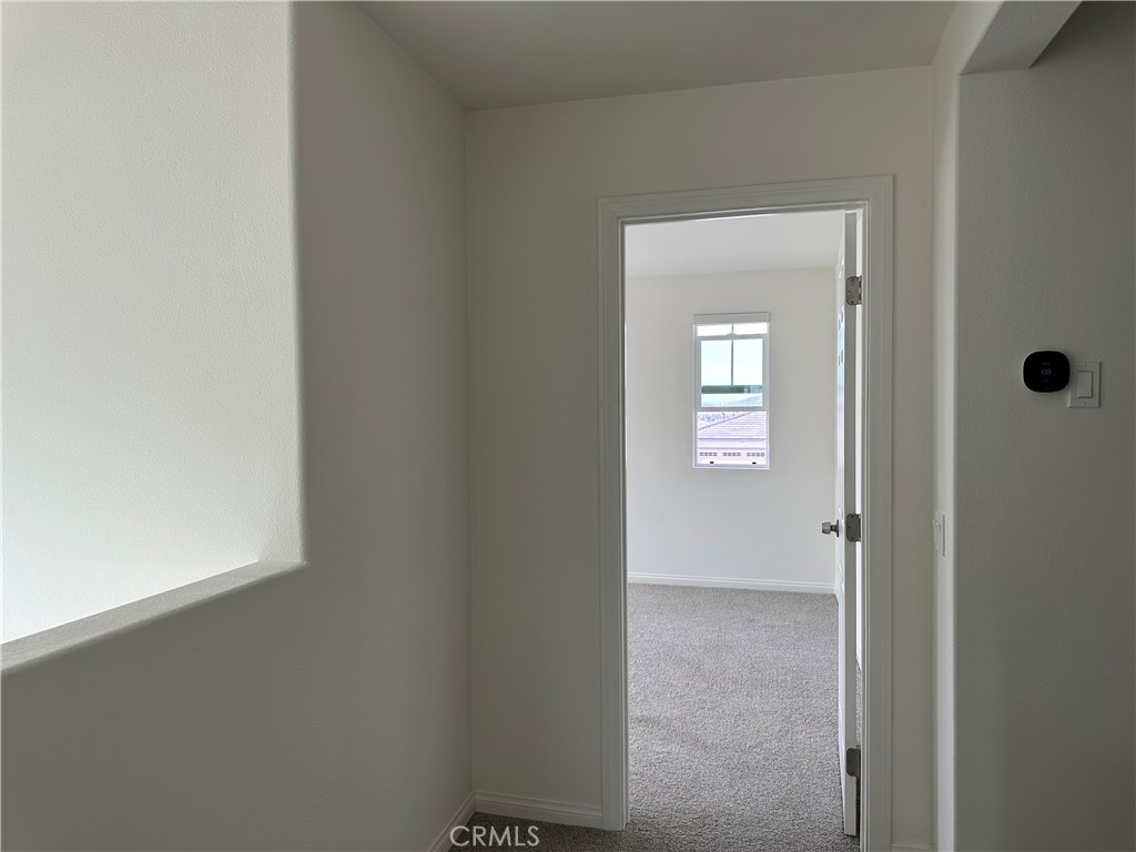 7560 Citrusmoon Court Riverside, CA 92507 - Photo 7 of 18 a view of a hallway with a door