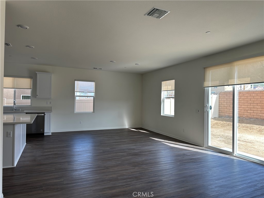 7560 Citrusmoon Court Riverside, CA 92507 - Photo 10 of 18 an empty room with wooden floor and windows
