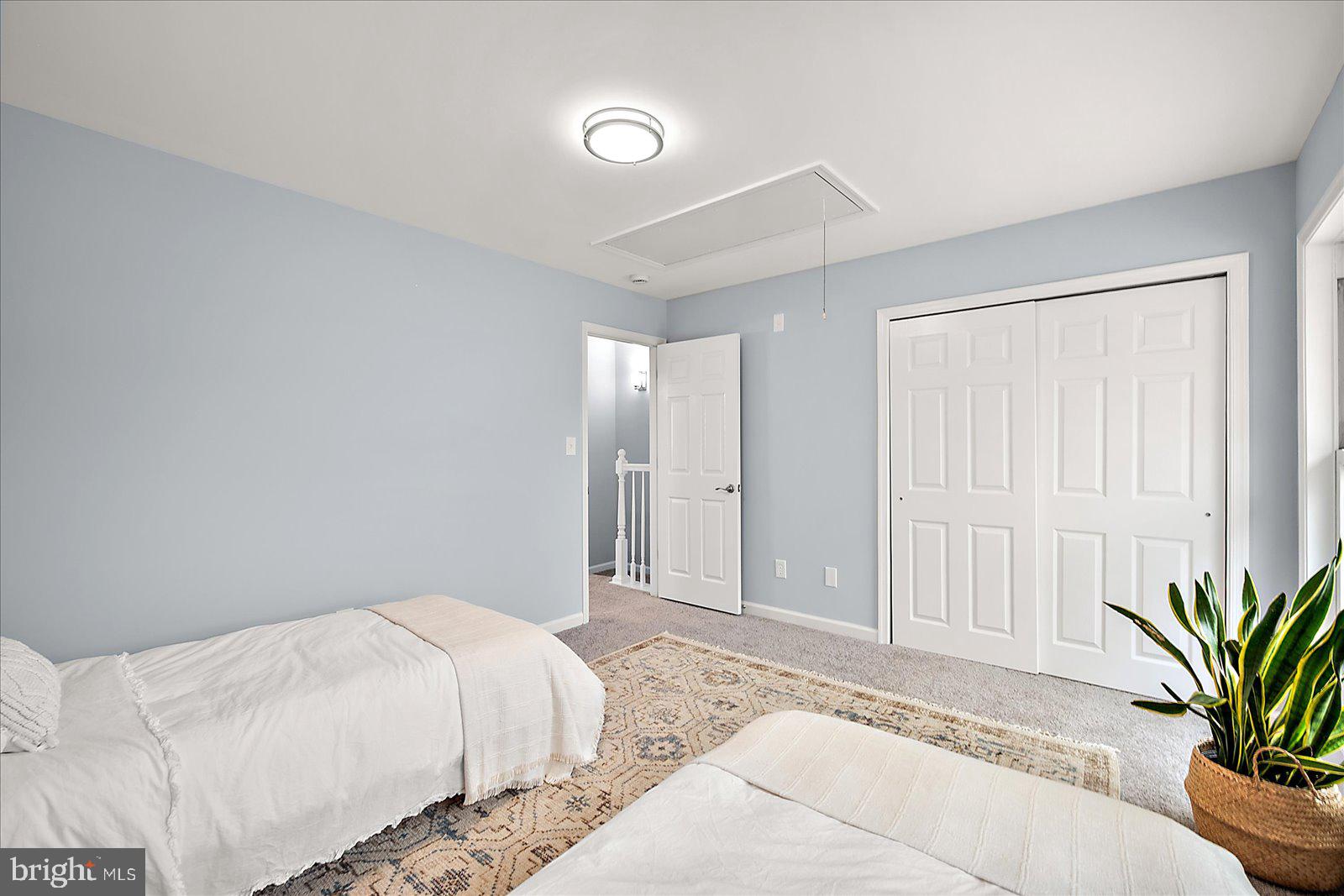 135 Jamestown Road, Unit 18A Ocean City, MD 21842 - Photo 36 of 63 a spacious bedroom with a bed and a potted plant