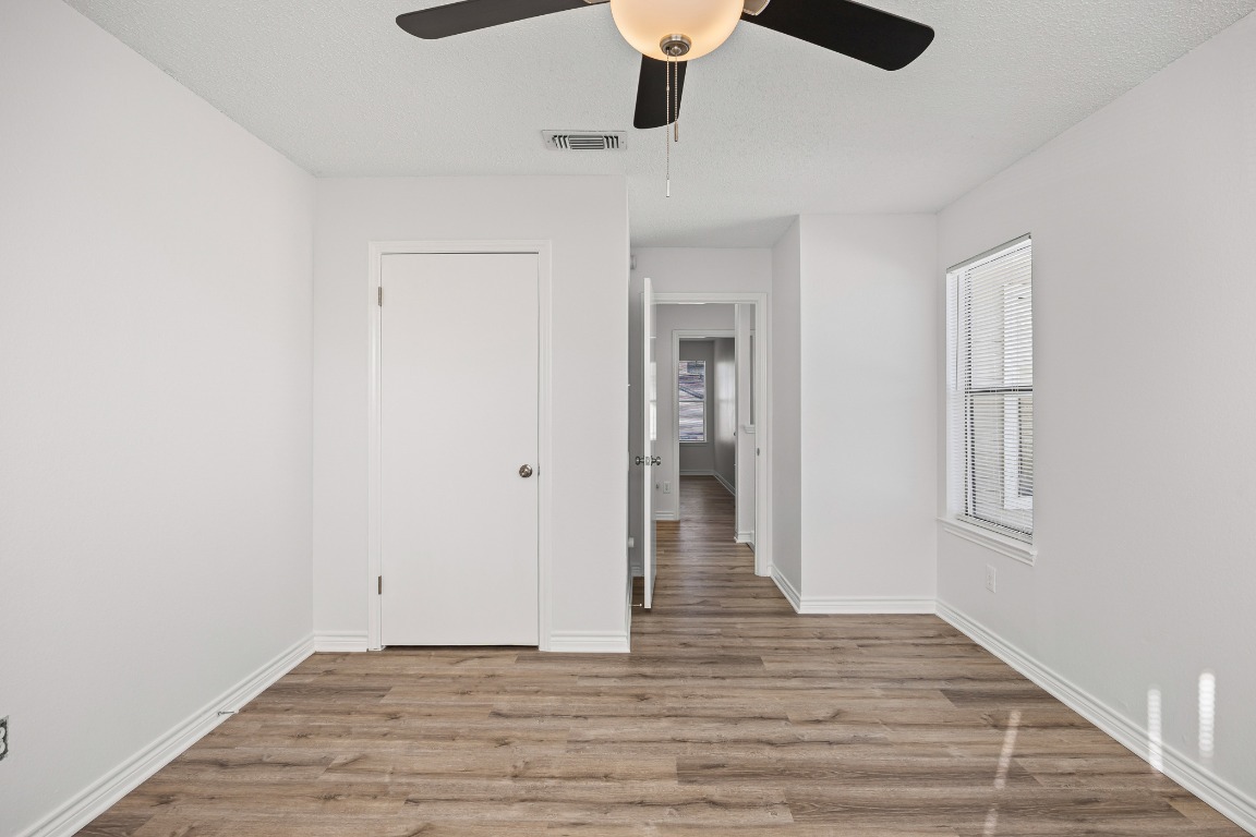 2630 Alcott Lane, Unit A Austin, TX 78748 - Photo 14 of 32 Unfurnished bedroom with light wood finished floors and a ceiling fan