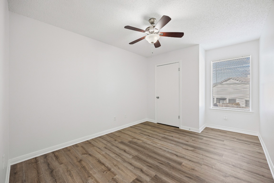 2630 Alcott Lane, Unit A Austin, TX 78748 - Photo 15 of 32 Unfurnished bedroom featuring a textured ceiling, wood finished floors, and ceiling fan