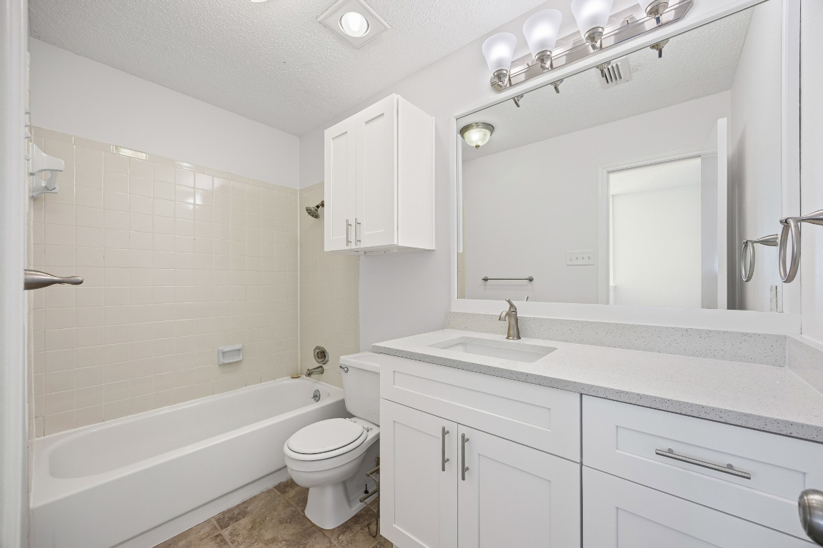 2630 Alcott Lane, Unit A Austin, TX 78748 - Photo 20 of 32 Full bath featuring a textured ceiling, shower / washtub combination, and vanity