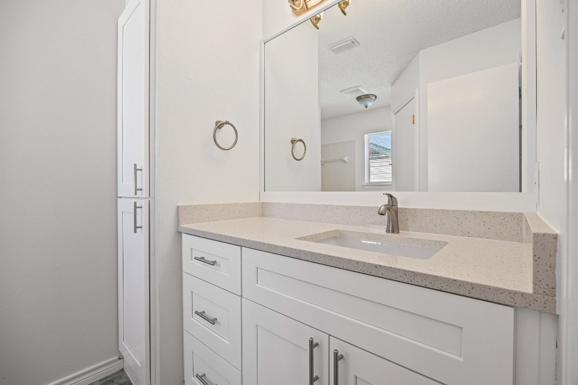 2630 Alcott Lane, Unit A Austin, TX 78748 - Photo 21 of 32 Bathroom with vanity and a textured ceiling