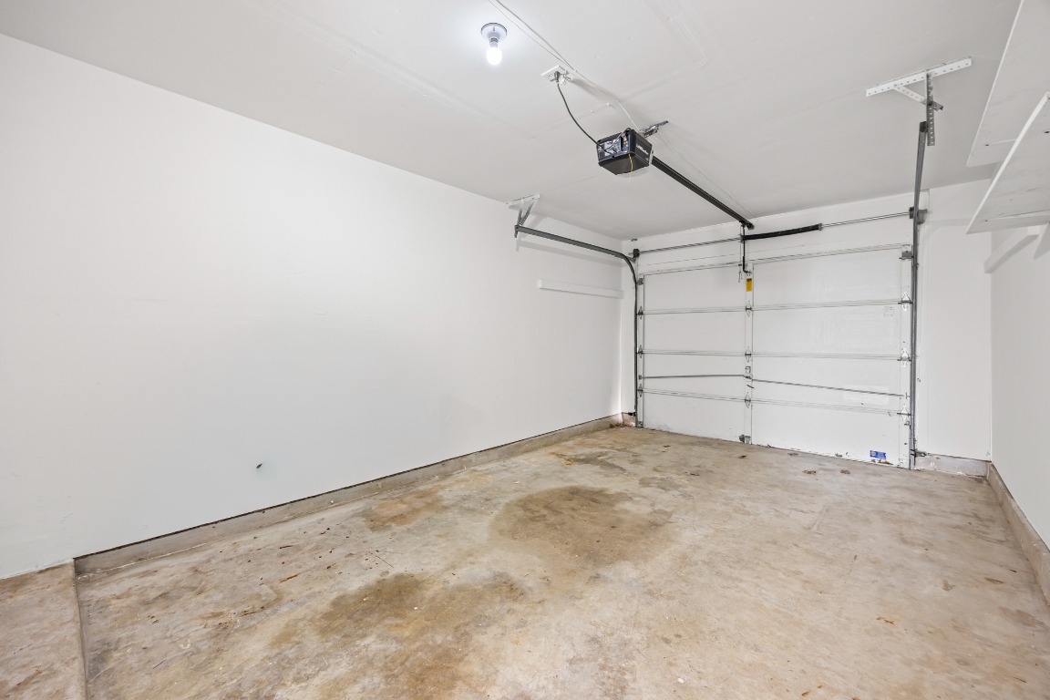 2630 Alcott Lane, Unit A Austin, TX 78748 - Photo 24 of 32 Garage featuring a garage door opener