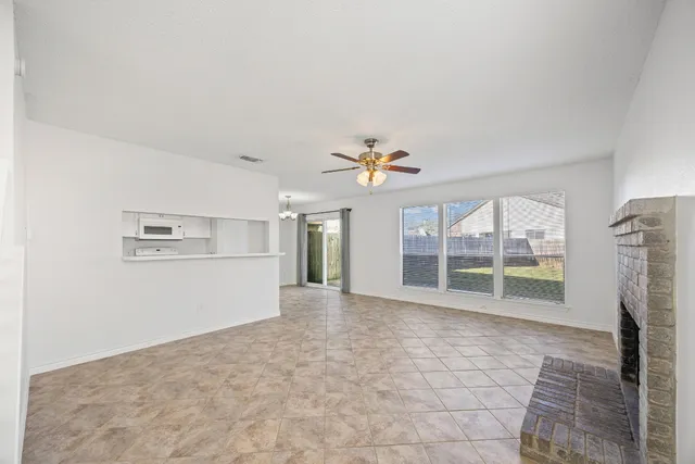a view of empty room with a fireplace