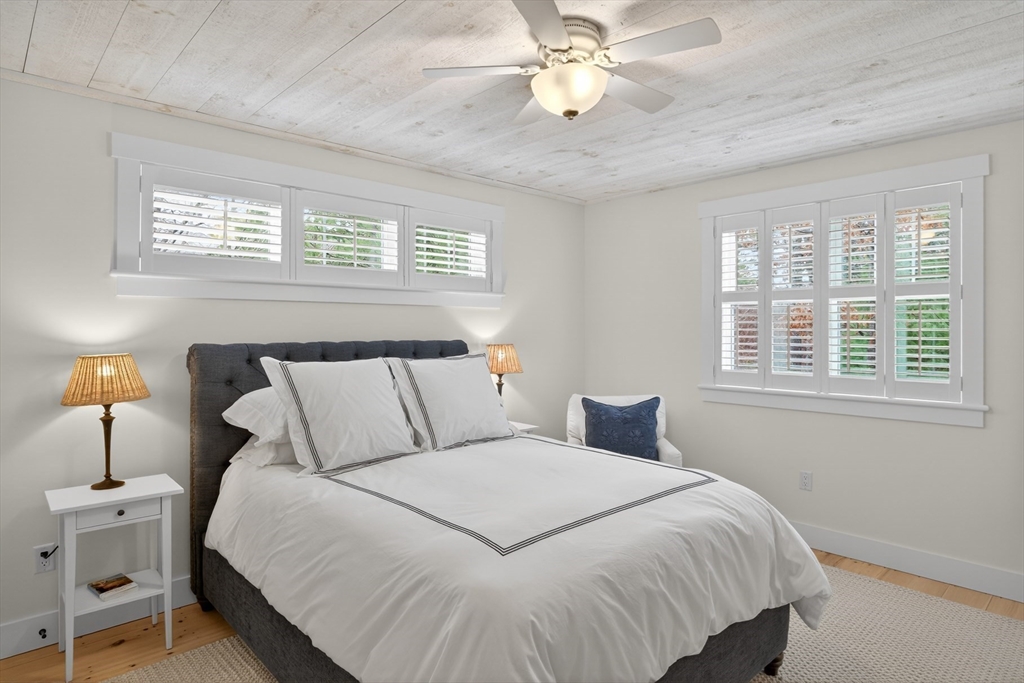 23 Cobblestone Plymouth, MA 02360 - Photo 18 of 39 a bedroom with a large bed and a chandelier